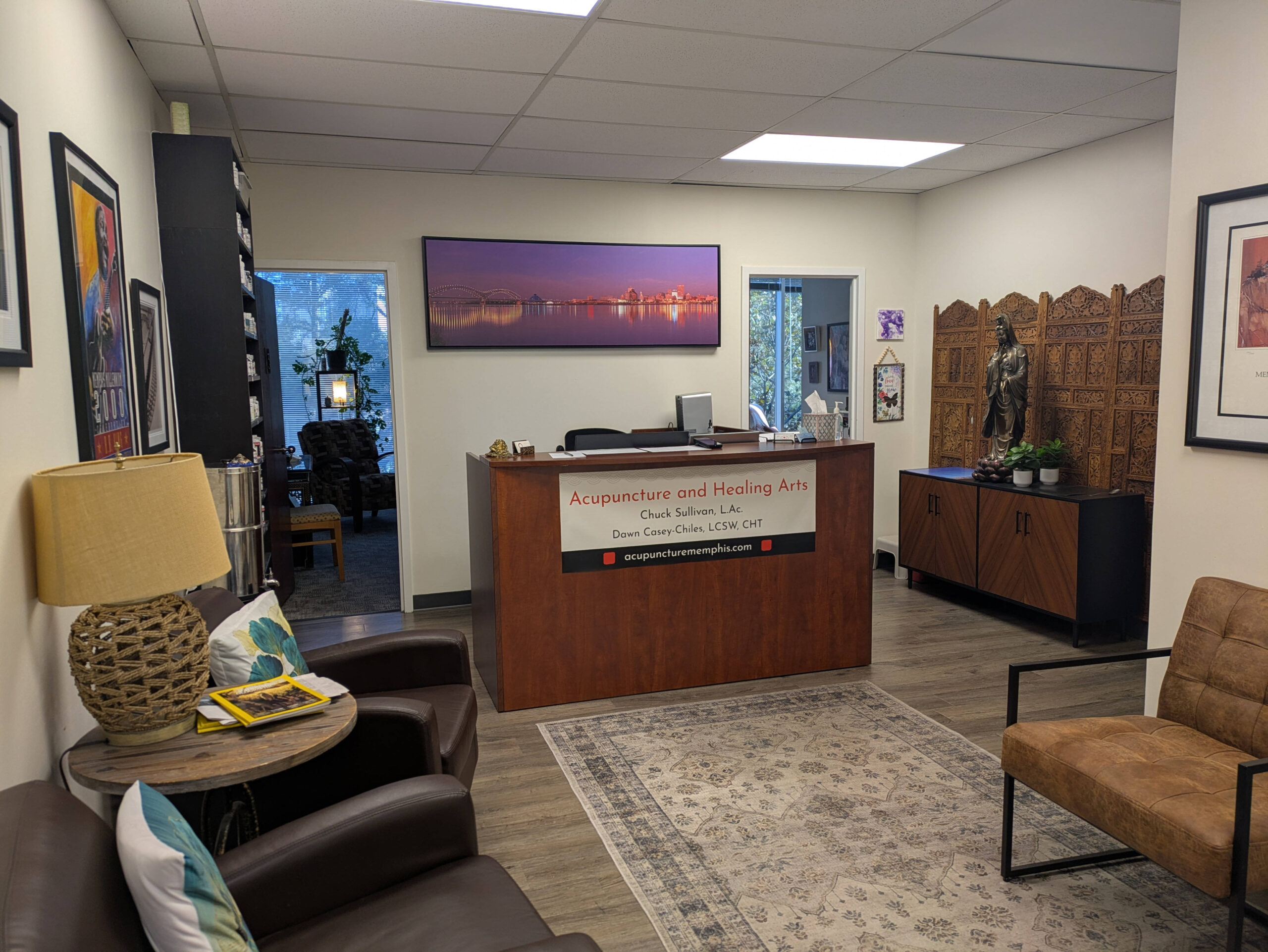 Waiting room with chairs and pictures and reception desk